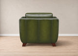 An olive green leather armchair with dark brown wooden legs, shown from the back against a neutral beige wall and light wood floor.