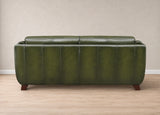 An olive green leather loveseat sofa with vertical channel tufting and dark wood legs, shown from the back in a minimalist room setting with a beige wall and light wood floor.