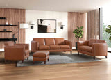 Brown leather sofa set in a modern living room with wooden floor and large windows.