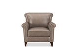 A classic wingback armchair upholstered in taupe leather with dark brown wooden legs and nailhead trim, shown against a plain white background.