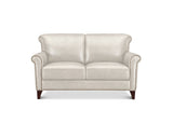 An off-white leather loveseat with dark brown wooden legs and silver nailhead trim, shown against a plain white background.