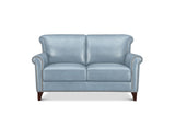 A light blue leather loveseat with dark brown wooden legs and silver nailhead trim, shown against a plain white background.