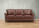 Brown leather sofa on a wooden floor with a gray wall background