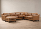 A curved sectional sofa upholstered in warm tan leather, featuring a left-facing chaise ottoman and dark wooden legs, set against a neutral beige wall and light wood floor.