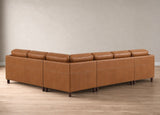 A modern L-shaped sectional sofa upholstered in warm tan leather, shown from a three-quarters angle against a neutral beige wall and light wood floor.