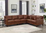 Brown leather sectional sofa in a living room setting with decor elements.