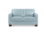 A light blue upholstered loveseat with square arms, two seat cushions, and dark brown wooden feet, shown against a plain white background.