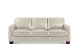 A three-seat sofa upholstered in light beige leather, featuring square arms, a low profile, and dark brown wooden legs, shown against a plain white background.