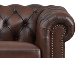 Brown leather armchair with tufted backrest and nailhead trim on a white background