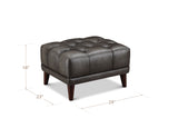 A dark brown tufted leather ottoman with wooden legs, shown on a white background with dimension lines indicating its height of 18 inches, width of 23 inches, and depth of 29 inches.