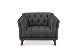A dark gray tufted armchair with dark brown wooden legs, shown from a front-facing perspective on a white background.