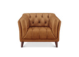 A classic Chesterfield-style armchair upholstered in warm camel brown leather, featuring deep button tufting on the backrest and seat, rolled arms, and dark wooden legs, shown against a plain white background.
