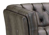 Close-up of a brown leather sofa with tufted backrests on a white background