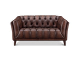 A classic brown leather loveseat sofa with deep button tufting on the backrest and seat, supported by dark wooden legs, shown against a plain white background.