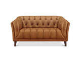 A classic Chesterfield loveseat sofa upholstered in warm camel brown leather, featuring deep button tufting on the backrest and seat, rolled arms, and dark wood legs, shown against a plain white background.