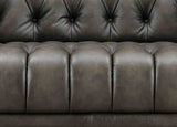 Close-up of a brown leather sofa with tufted backrest