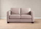 A two-seater loveseat sofa upholstered in a light beige fabric, positioned against a textured beige wall on a light wood floor.