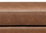 Close-up of a brown leather surface with visible stitching
