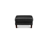 A modern two-tiered ottoman stool upholstered in black textured fabric or leather, featuring dark brown wooden legs, shown against a plain white background.
