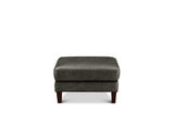 A dark gray upholstered ottoman with dark brown wooden legs, shown from the front against a plain white background.