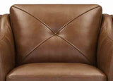 Close-up of a brown leather armchair with diamond pattern stitching.