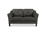 A dark gray faux leather loveseat with diamond-quilted back cushions and dark brown wooden legs, shown against a plain white background.