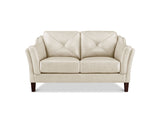 A cream-colored two-seater loveseat sofa with diamond-quilted back cushions, rolled arms, and dark brown wooden legs, shown against a plain white background.