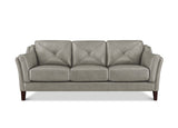 A three-seat sofa upholstered in light taupe leather with diamond tufting on the back cushions and dark brown wooden legs, shown against a plain white background.