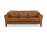 A three-seat sofa upholstered in warm tan leather with diamond-quilted back cushions and dark wooden legs, shown against a plain white background.