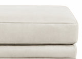 Close-up of a light gray leather ottoman on a white background