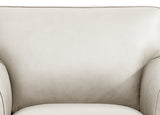 Close-up of a beige armchair with a soft texture