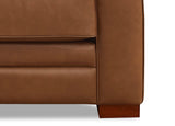 Close-up of a brown leather sofa corner on a white background