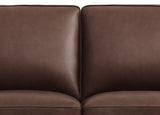 Close-up of a brown leather sofa with a white background