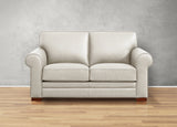 Beige sofa on a wooden floor with a gray wall background