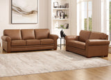 Brown leather sofa set in a living room with a rug and wall art.