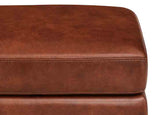 Close-up of a brown leather ottoman with a white background