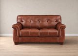 A classic brown leather loveseat sofa with tufted back cushions and rolled arms, set against a neutral beige wall and light wood floor.