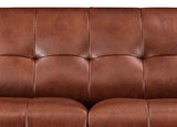 Close-up of a brown leather sofa with visible stitching