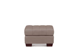 A rectangular tufted ottoman in taupe leather with dark brown wooden legs, shown from the front on a solid white background.