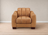 A modern tan leather armchair with a segmented backrest and dark wooden legs, set against a neutral beige wall and light wood floor.