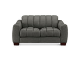 A dark gray upholstered loveseat with vertical channel tufting on the backrest and seat cushions, shown against a plain white background.