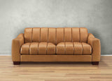 Brown leather sofa against a gray wall on a wooden floor