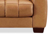 Close-up of a brown leather sofa corner on a white background