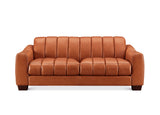 A modern two-seater sofa upholstered in warm cognac brown leather, featuring vertical channel tufting on the backrest and seat cushions, set against a plain white background.