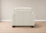 A modern armchair upholstered in light beige leather, shown from the back against a neutral beige wall and light wood floor.