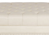 Close-up of a tufted headboard with decorative buttons on a white background