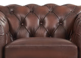 Close-up of a brown leather sofa with tufted backrest