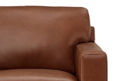 Close-up of a brown leather sofa on a white background