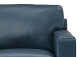 Close-up of a blue leather sofa on a white background