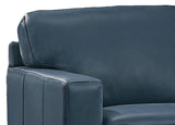 Close-up of a blue leather sofa corner on a white background